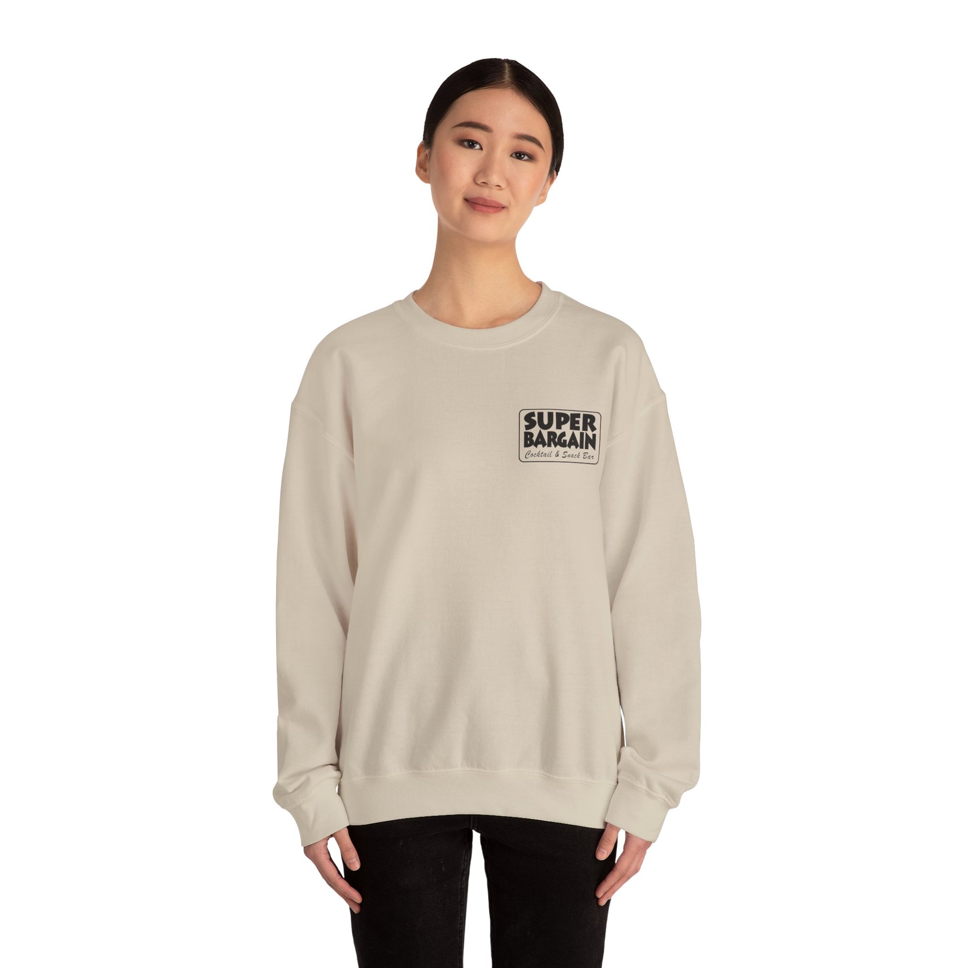 A woman stands straight, wearing a Printify Unisex Heavy Blend™ Crewneck Monochrome Logo and Cabbagetown sweatshirt with the text “SUPER BARGAIN” printed on the front, paired with black pants, against a white background in Toronto.