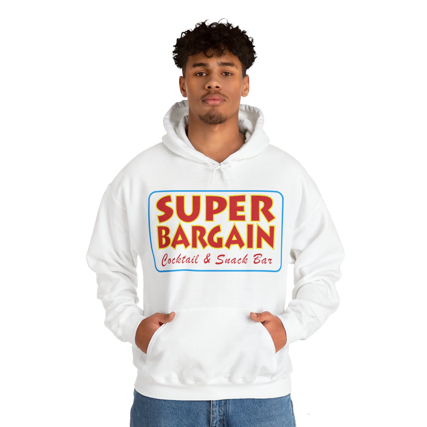 A young man wearing a white Unisex Heavy Blend™ Hooded Sweatshirt with "SUPER BARGAIN Cocktail & Snack Bar" printed on the front, standing against a plain background in Cabbagetown, Toronto.