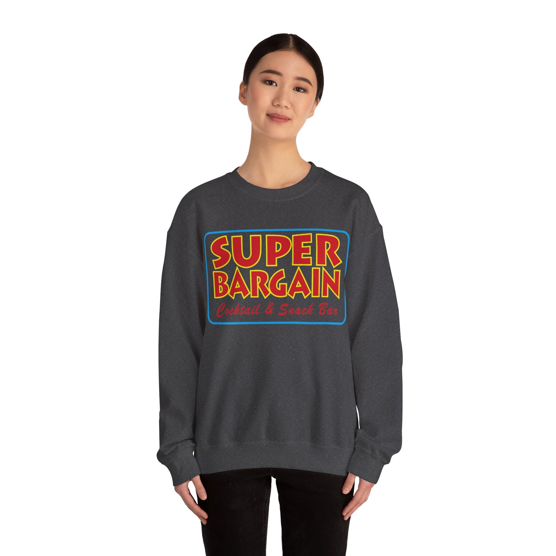 A woman models a gray Unisex Heavy Blend™ Crewneck Signature Logo Sweatshirt featuring a colorful "Toronto Super Bargain Cocktail & Snack Bar" logo on the front from Printify.