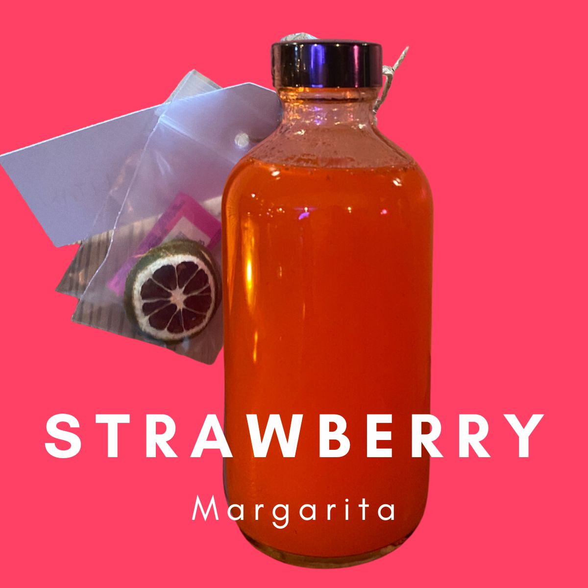 A vibrant pink Strawberry Margarita RTD Cocktail Gift Box from Super Bargain Shop in a transparent bottle against a pink background, with the label "RTD STRAWBERRY Margarita" displayed prominently. A sliced lime and a small bag of spices are next to the bottle.